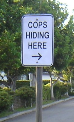 We will be telling scofflaws exactly where red light cameras are, so why not require cities to post this sign too?